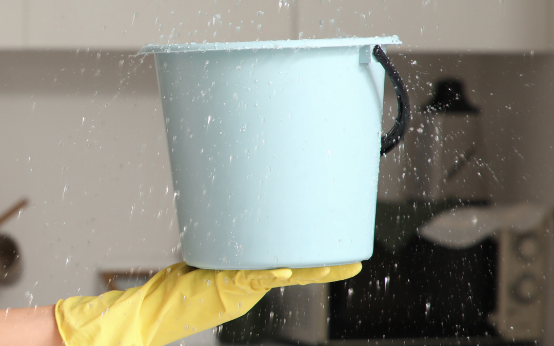 property insurance claims UK water leak bucket catching water from ceiling