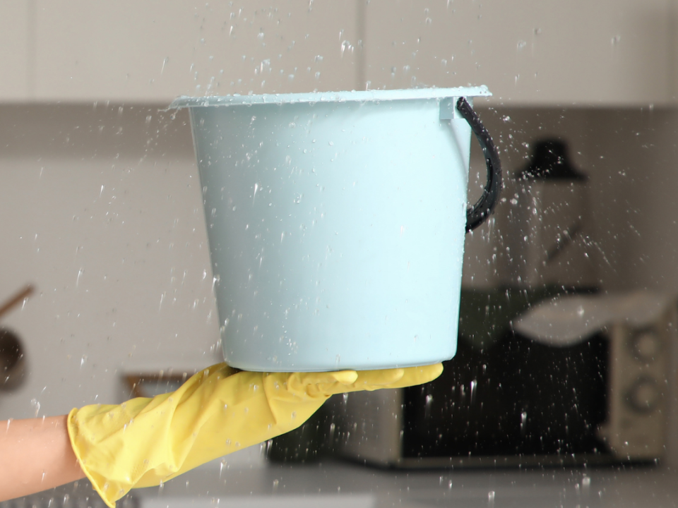property insurance claims UK water leak bucket catching water from ceiling
